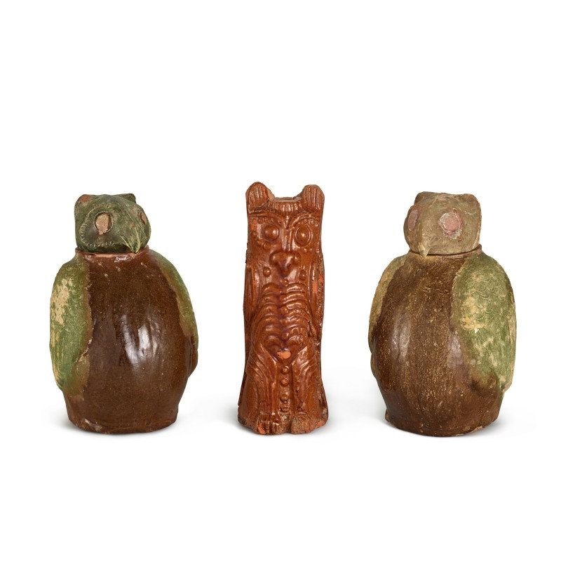 A pair of brown and green-glazed 'owl' jars and covers, and a brown-glazed pottery figure of an owl, Han dynasty (206 BC-220 AD)