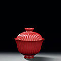 An inscribed red lacquer 'chrysanthemum' tea bowl and cover, qianlong four-character seal marks and of the period