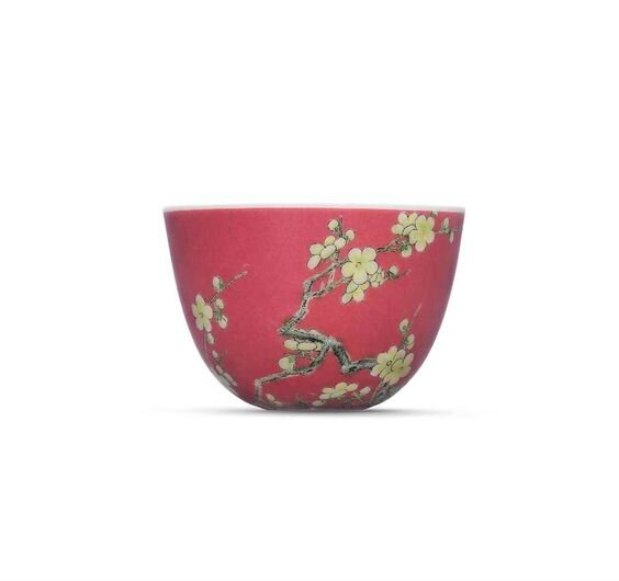 A fine and highly important falangcai ruby-ground ‘prunus’ cup, Yongzheng four-character mark in blue enamel and of the period (1723-1735)