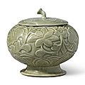 A rare 'Yue' carved celadon globular 'floral' vessel and cover, Five Dynasties (907-960)