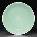 A celadon-glazed molded flower-form dish, Qianlong six-character seal mark in underglaze blue and of the period (1736-1795)