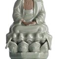 A rare moulded 'Longquan' celadon figure of Buddha Shakyamuni, China, Ming dynasty, 15th century