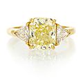 An 18 karat yellow gold, fancy intense yellow diamond and diamond ring, cartier