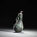 A rare archaic bronze ‘gourd’ vase and cover, hu, eastern zhou dynasty