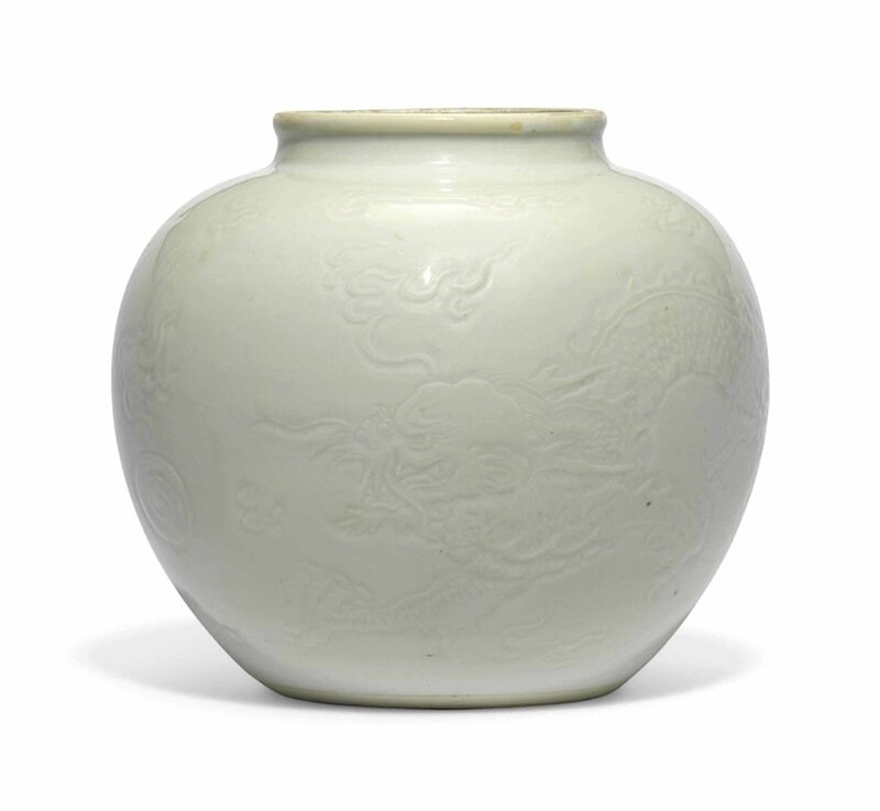 A carved white-glazed 'dragon and phoenix' jar, Kangxi-Yongzheng period (1662-1735)