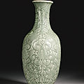 A rare moulded and carved celadon-glazed vase, qianlong seal mark and period (1736-1795)