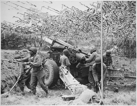 773px-Troops_of_a_field_artillery_battery_emplace_a_155mm_howitzer_in_France__They_have_been_following_the_advance_of_the _____ _-_-_ NARA 531198