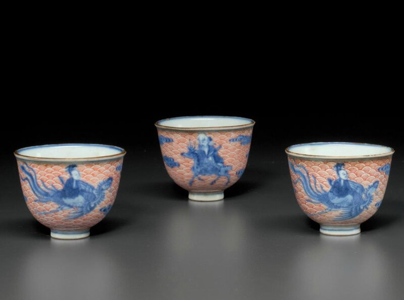 A set of three iron-red-decorated blue and white wine cups, Qianlong four-character seal marks in underglaze blue and of the period (1736-1795)
