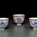 A set of three iron-red-decorated blue and white wine cups, qianlong four-character seal marks and of the period