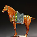 A very well-modeled blue and sancai-glazed pottery figure of a caparisoned horse, Tang dynasty (AD 618-907)