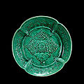 A molded green-glazed pottery dish, liao dynasty, 10th-12th century