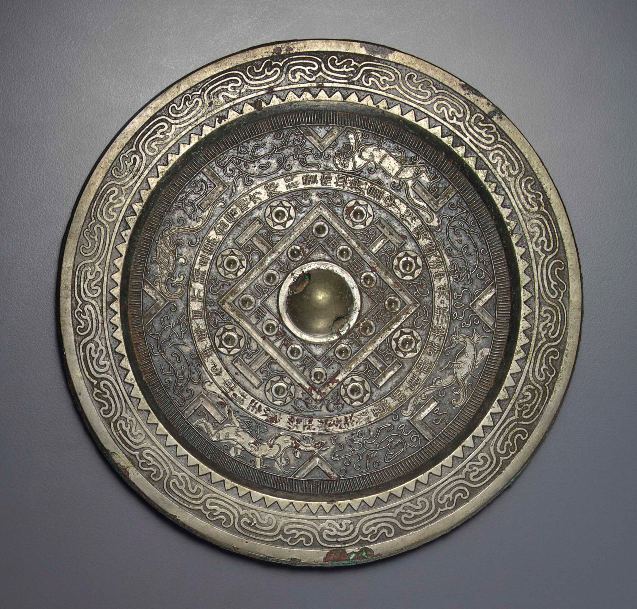 A bronze circular 'TLV' mirror, Xin dynasty (AD 9-24)