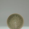 A Yaozhou carved celadon 'Peony' conical bowl, Northern Song Dynasty (960-1127)