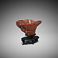 A Chinese carved rhinoceros horn 'magnolia' libation cup, 17th-18th century