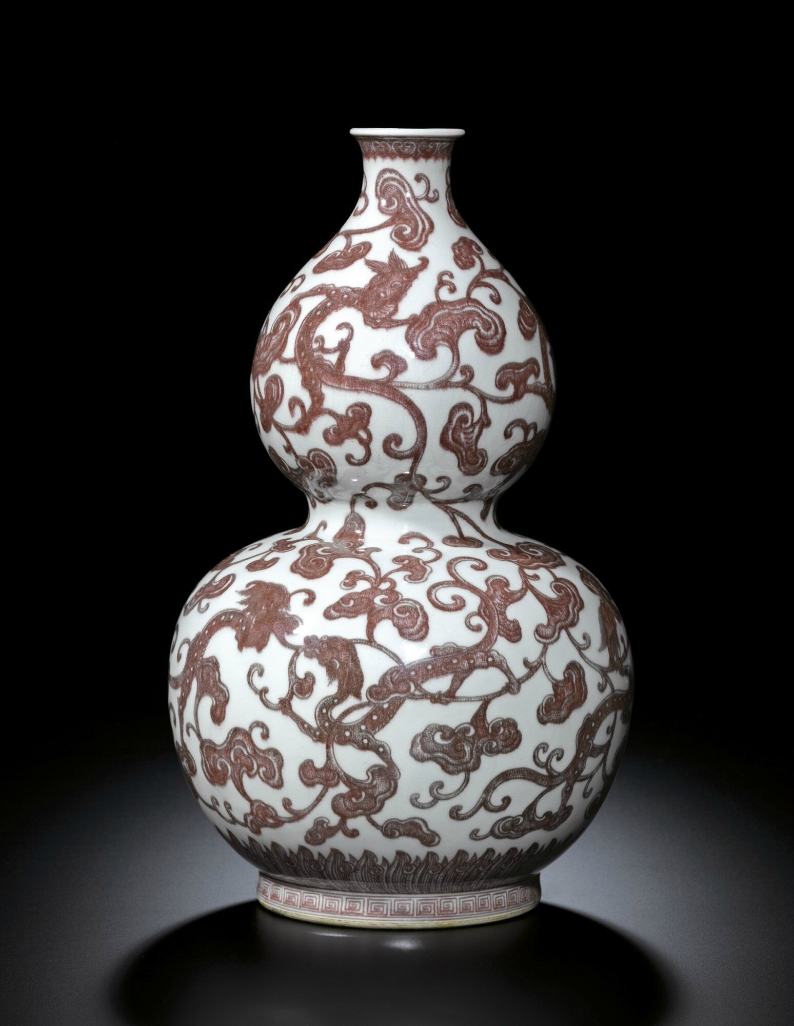 A fine and rare copper-red 'dragon' 'lingzhi' double-gourd vase