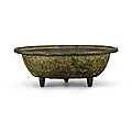 An inscribed bronze 'dragon and phoenix' washer, yuan dynasty (1279-1368)