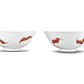 A rare pair of copper-red-decorated 'five bats' bowls, yongzheng six-character marks and of the period (1723-1735)