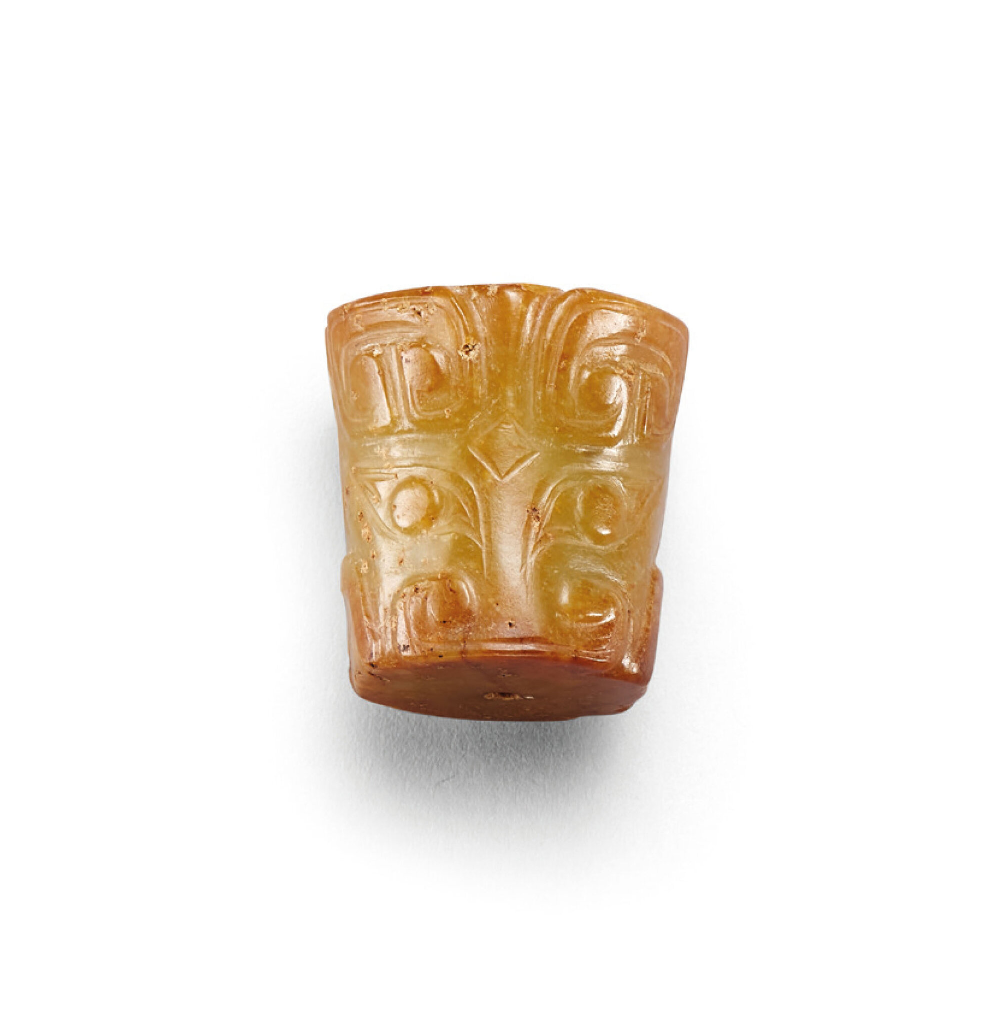 A celadon jade cylindrical ‘animal mask’ pendant, Shang-Western Zhou dynasty (1600-771 bc)