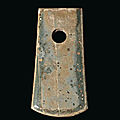 A greenish-grey stone axe, neolithic period, circa 4th-3rd millennium bc