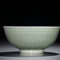 A fine incised and moulded celadon-glazed 'peony' bowl, qianlong six-character seal mark and of the period (1736-1795)