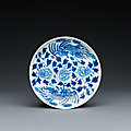 a-chinese-blue-and-white-bleu-de-hue-dish-with-phoenixes-for-dng-huy-tr-1825-1874-dng-huy-tr-mark-and-inscription-dated-1868