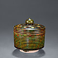 A sancai-glazed cylindrical jar and cover, Tang dynasty, 618-907