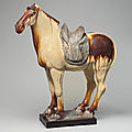 A chestnut and straw-glazed pottery figure of a horse, Tang dynasty (618-907)