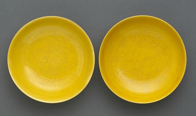 A pair of incised yellow glazed dragon porcelain saucer dishes, Daoguang marks and of the period (1821-1850