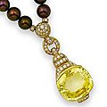 A yellow sapphire, diamond, and cultured pearl pendant/necklace by cartier. 