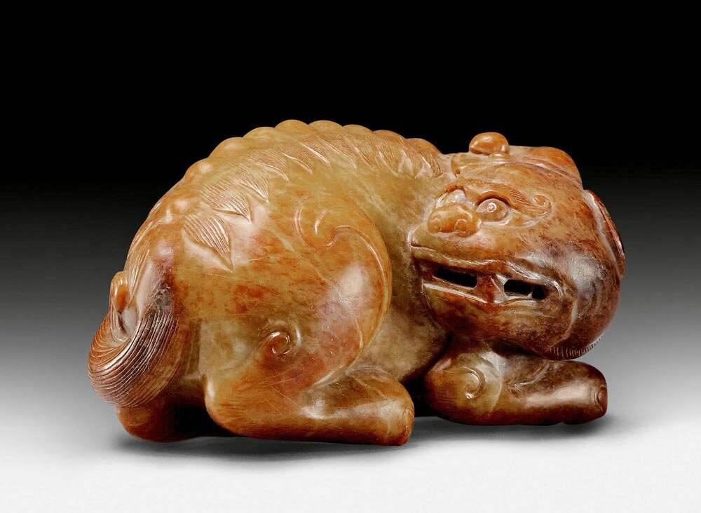 A mottled brown jade carving of a mythical beast, China, Ming dynasty