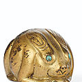 A rare gilt-bronze weight in the form of a recumbent hare, tang dynasty (ad 618-907)