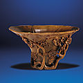 A carved rhinoceros horn 'prunus' libation cup, qing dynasty, 18th century